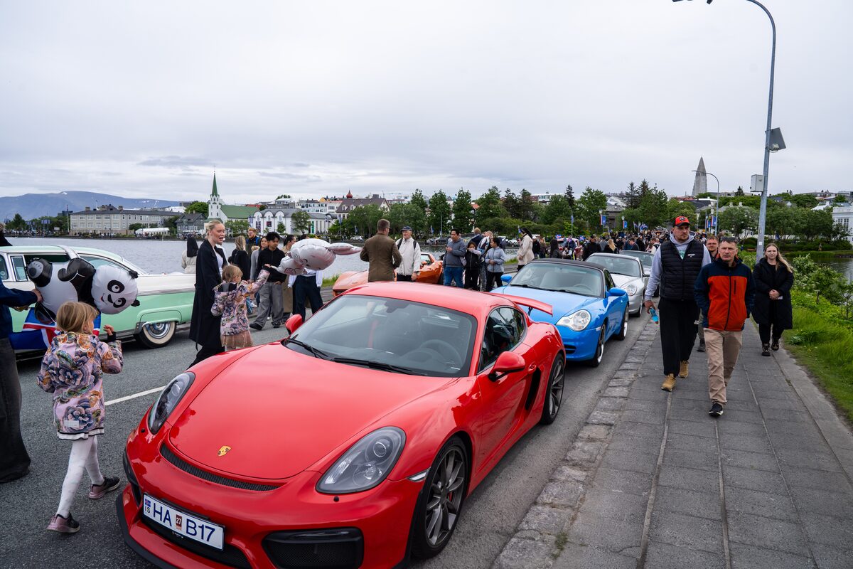 Classic cars line a street beside Tjörnin pond during June 17 celebrations in Reykjavík.