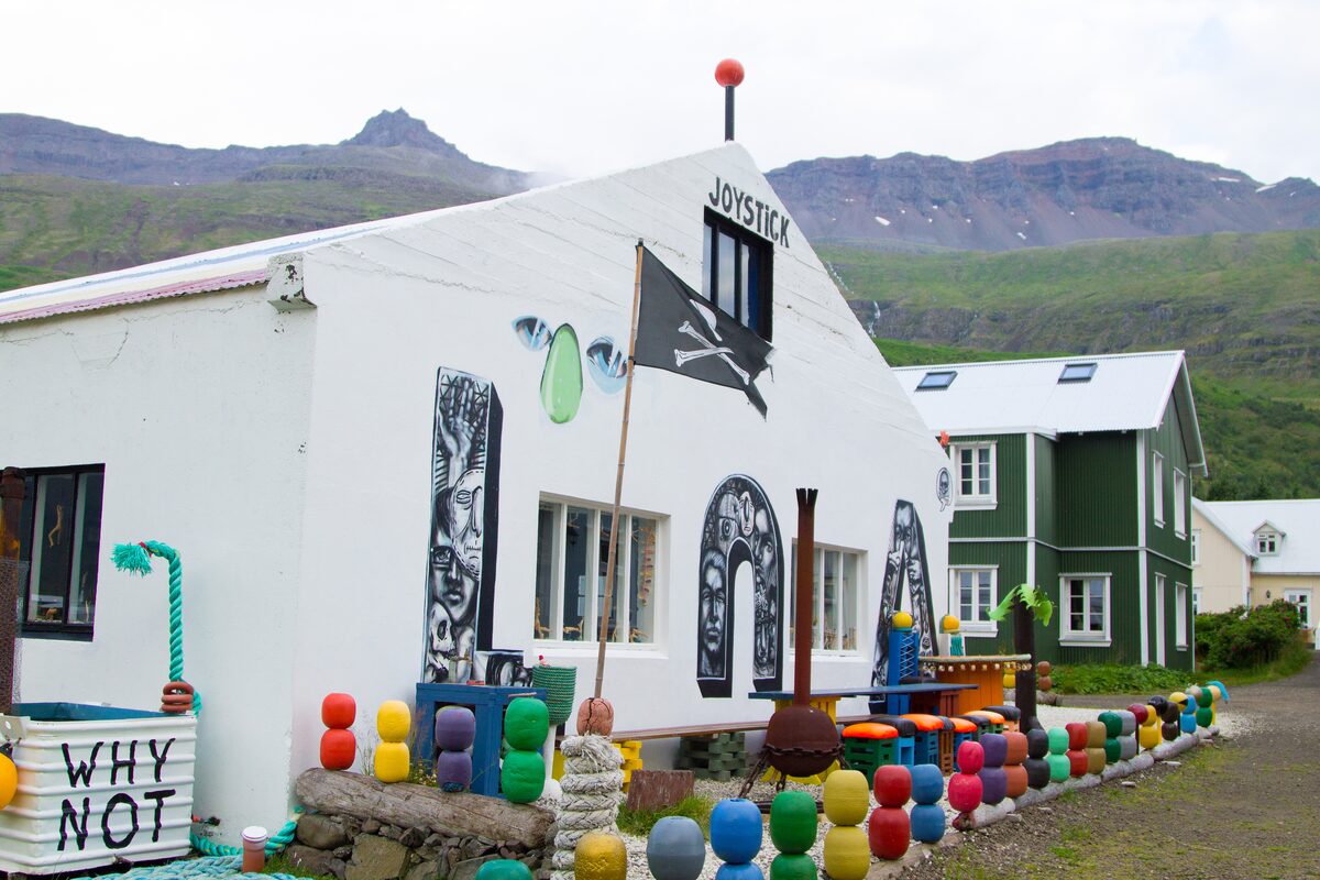 Art gallery on Rainbow Street with a pirate flag and colorful buoys along the fence.