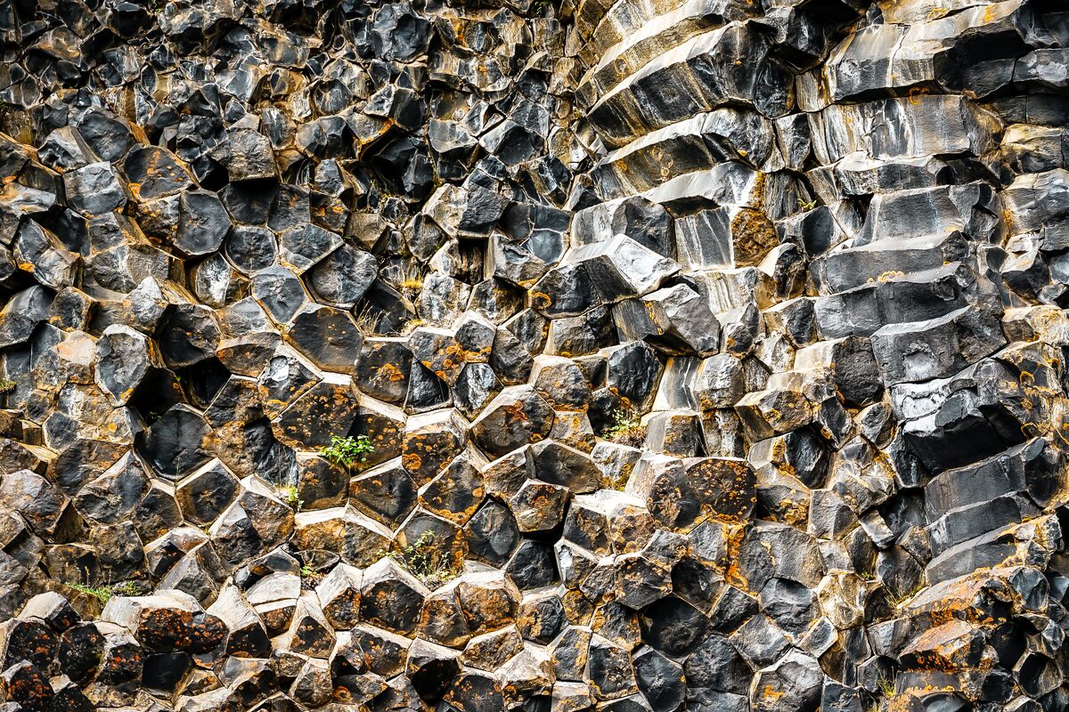 Close-up of curved and honeycomb-patterned basalt columns at Hljóðaklettar.