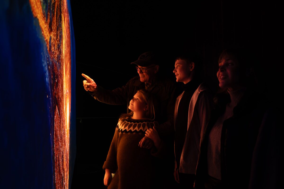 Family Looking At An Instilation At Lava Centre in Iceland
