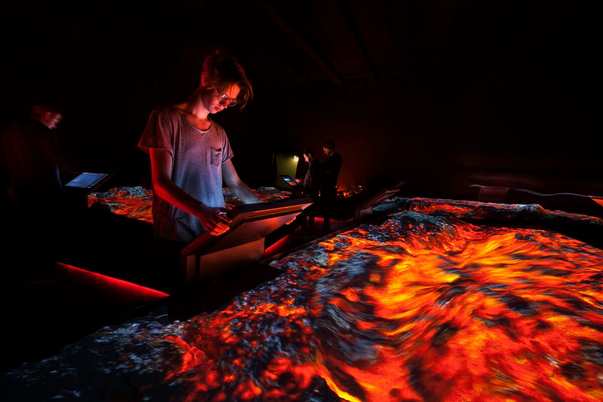 Young Man Looking At An Instilation At Lava Centre in Iceland