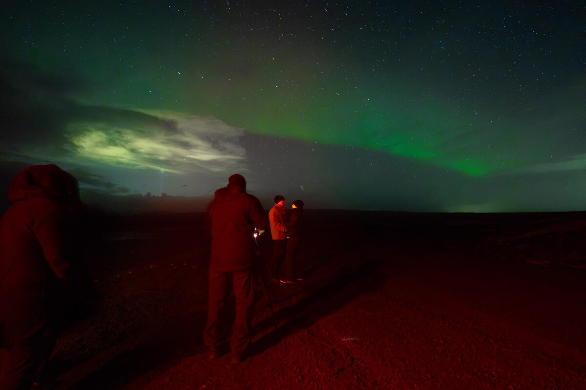 Couple Posing For A Picture Under Northern Lights in Iceland