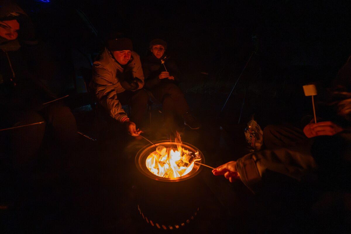 People Roasting Marshmallows Around A Campfire in Iceland