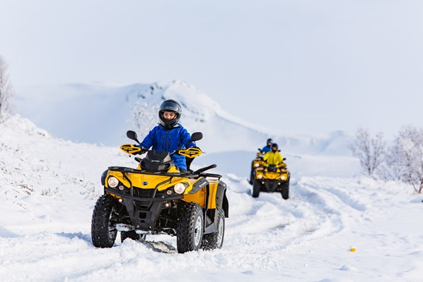 group of people driving ATV during wintertime