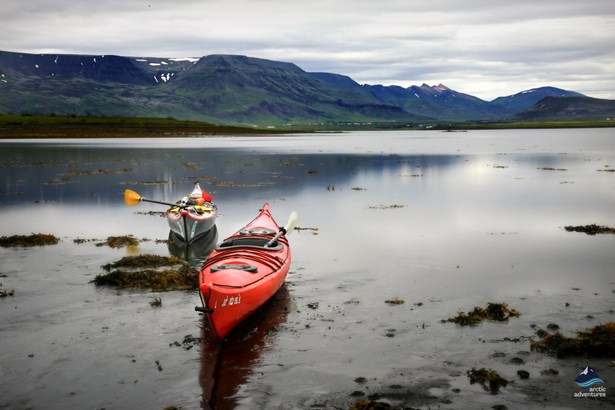 kayaks by the shore of Icelandic fjord