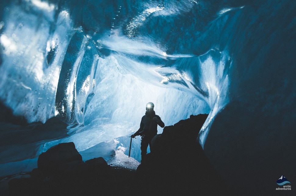 man in Vatnajokull ice cave at night
