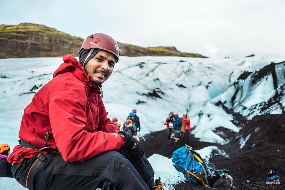 happy hiker resting during during glacier hike
