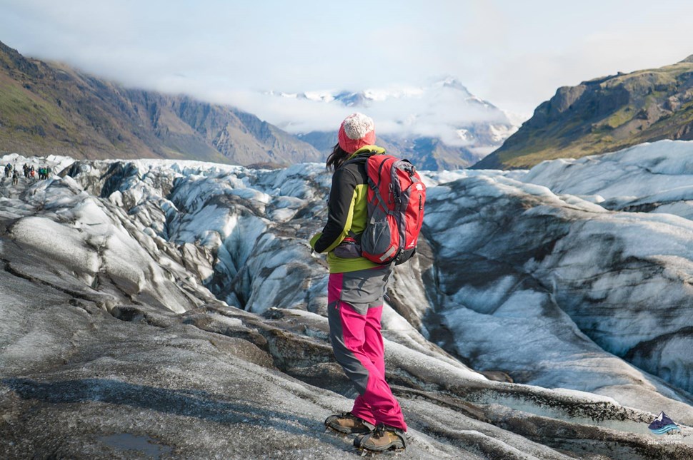A hiker admiring Svínafellsjökull Glacier in Iceland