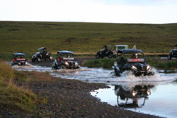 group of ATV drivers crossing river