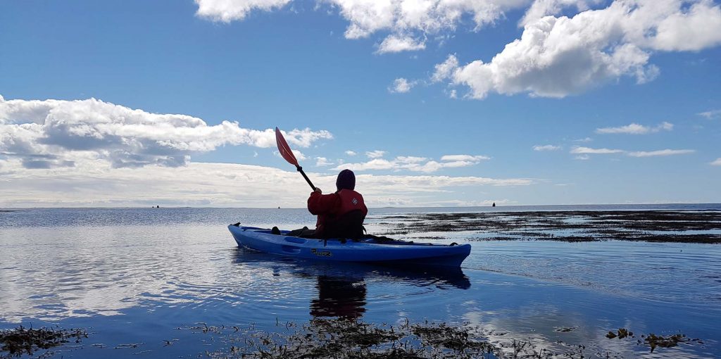 kayaker swimming in the sea during summer
