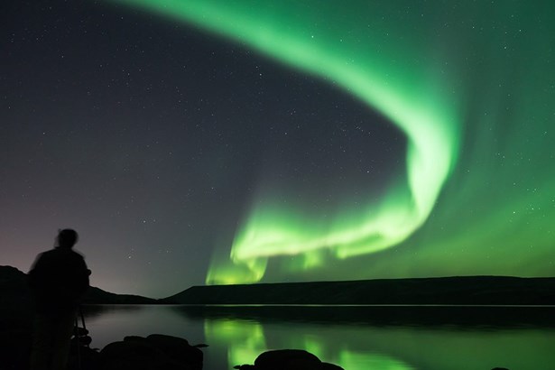 man photographs Northern Lights in Iceland