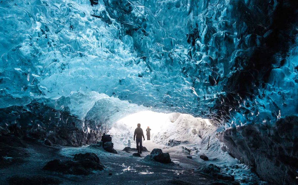 people taking pictures in ice cave
