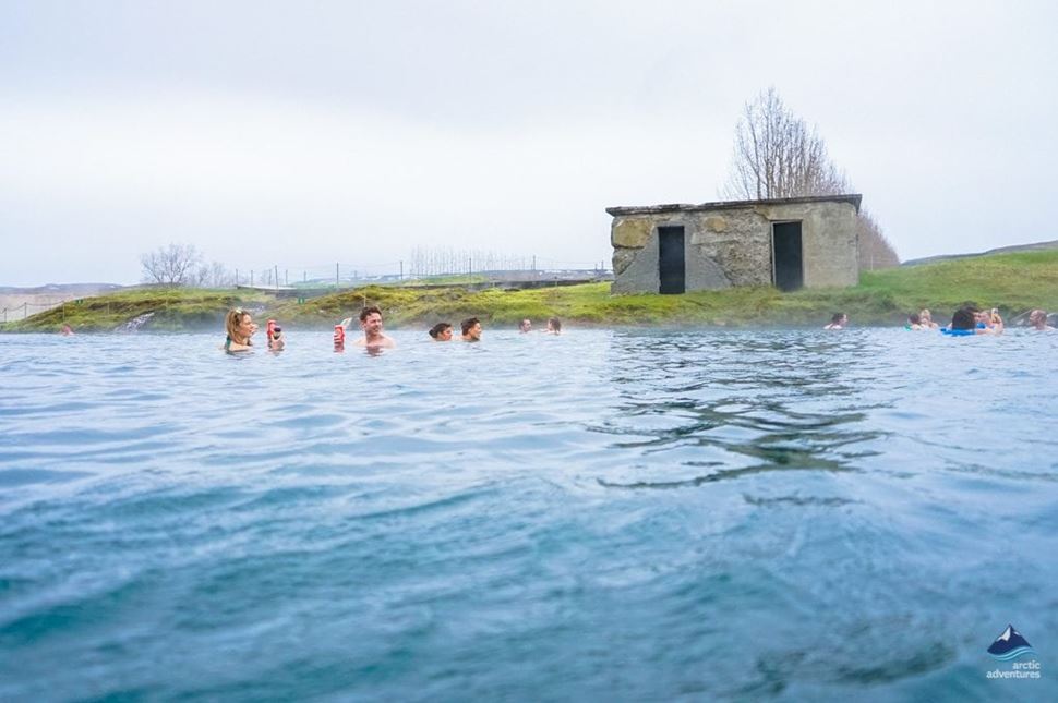 people bathing at Secret lagoon's hot spring