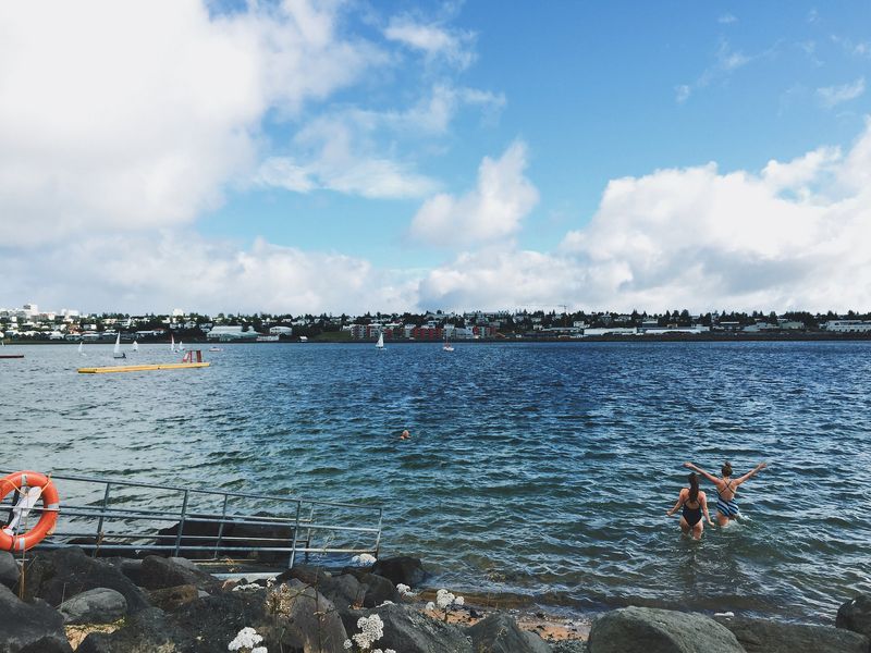 Two ladies are going to swim in the Nauthólsvík beach