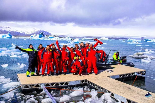 tourists group on footbridge in glacier lagoon
