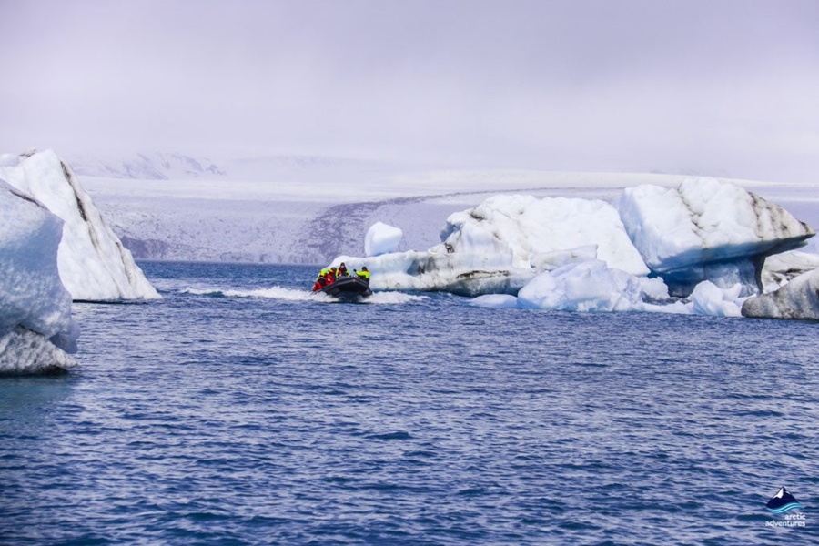 tourists explore glacier lagoon by boat