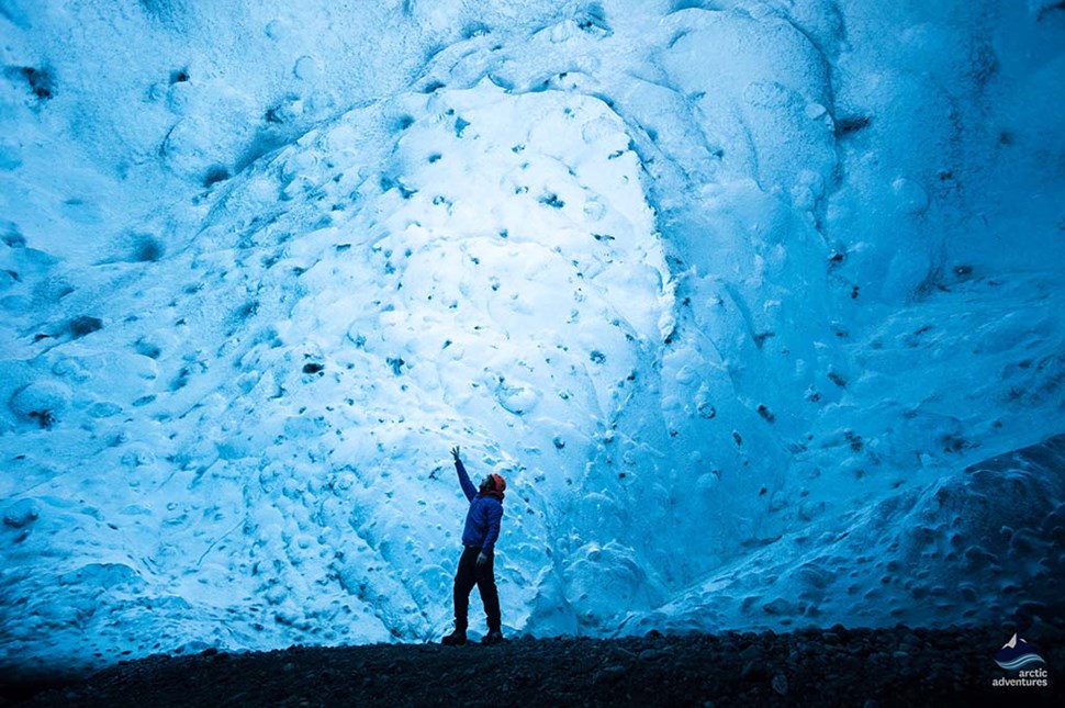 man inside Crystal ice cave in Iceland