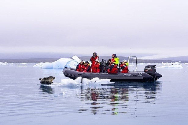 people exploring wildlife of glacier lagoon