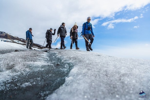 explorers walking on glacier ice