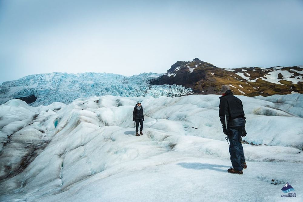couple walking on glacier