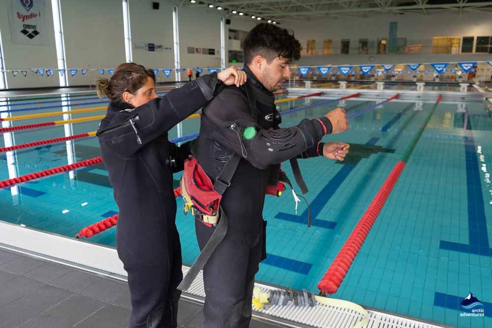 instructor putting dry suit
