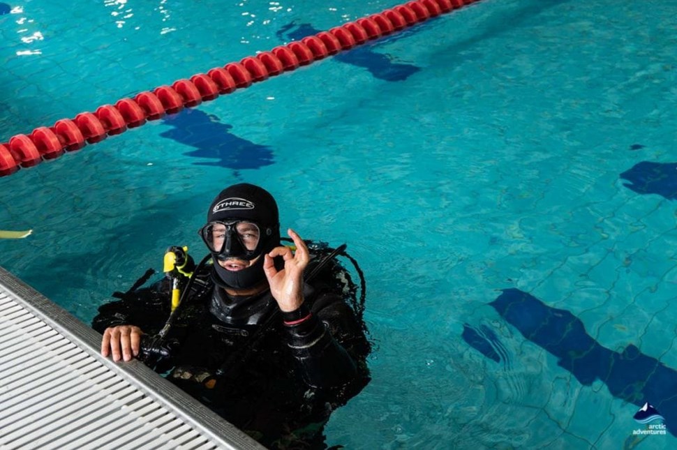 man diving in a pool of diving school