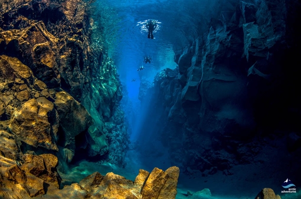 people diving by the surface in Silfra
