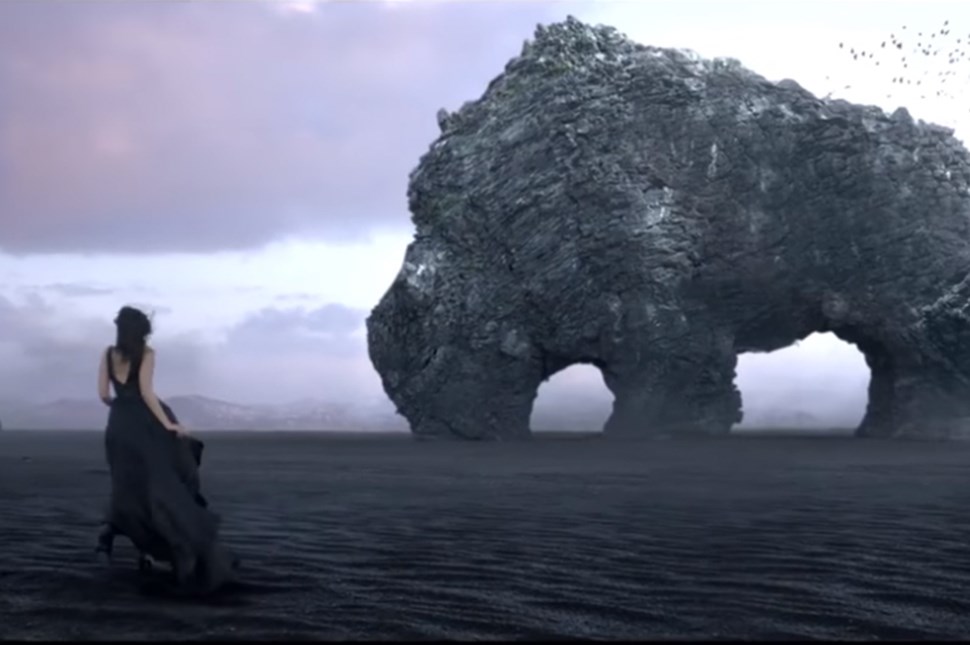 Woman in front of Hvitserkur rhino rock